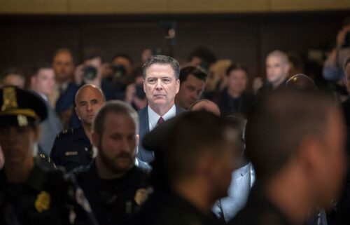 Former FBI director James Comey walks through a corridor on the way to a secure room to continue his testimony to the Senate Select Committee on Intelligence