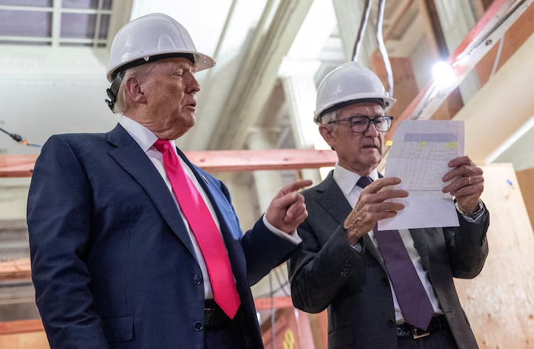 Donald Trump points to a cost sheet as he speaks with Federal Reserve chair Jerome Powell (R) as he visits the Federal Reserve in Washington, DC, on July 24, 2025.
