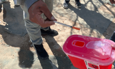 At the picadero along the train track, Montelongo and Rojas accept used syringes and hand out new ones. The man with the gray sweatshirt is Erick.