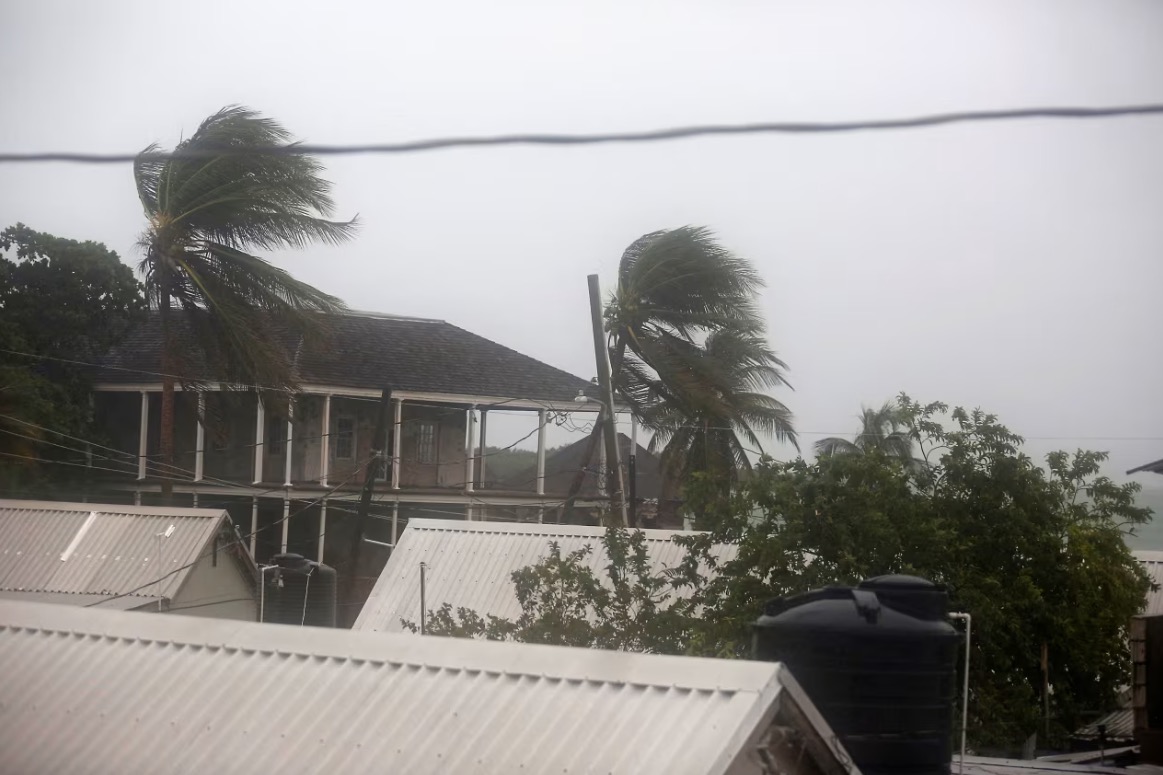 A person looks out at the sea as Hurricane Melissa approaches in Port Royal