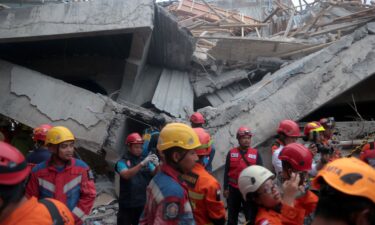 Rescuers search for survivors in the rubble on September 30