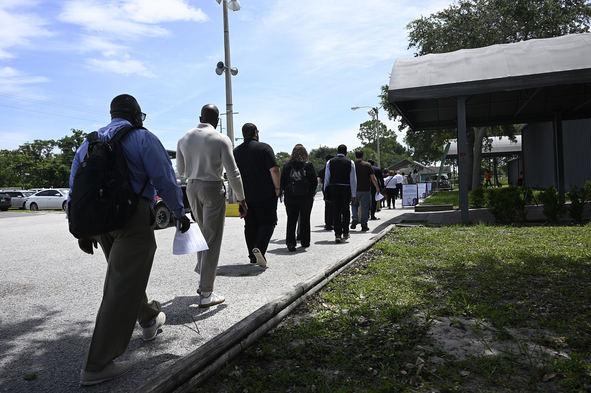 <i>Phelan M. Ebenhack/AP via CNN Newsource</i><br/>Job seekers walk in line to a job fair at the Central Florida Fairgrounds attended by employers looking to fill openings on July 10 in Orlando.