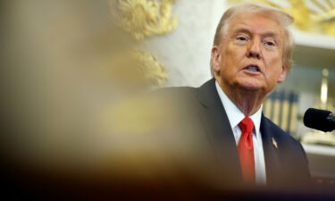 President Donald Trump answers questions from reporters in the Oval Office of the White House on Thursday.