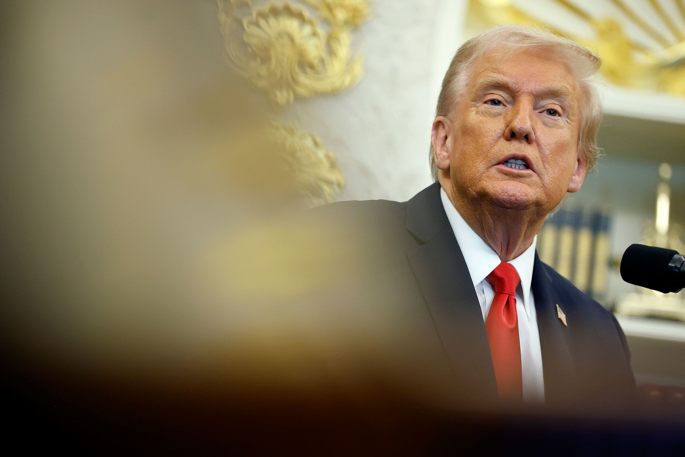 <i>Kevin Dietsch/Getty Images/File via CNN Newsource</i><br/>President Donald Trump answers questions from reporters in the Oval Office of the White House on Thursday.