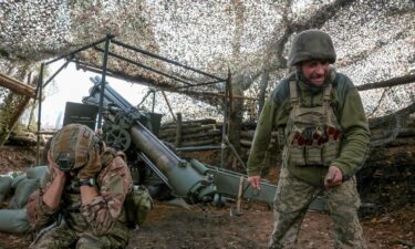 Ukrainian soldiers fire an M114 self-propelled howitzer towards Russian troops near the frontline town of Pokrovsk in Donetsk region