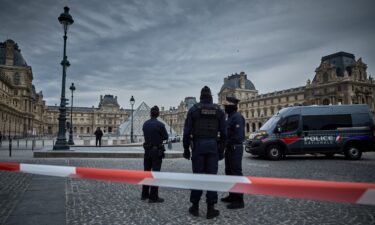 French police officers seal off the entrance to the Louvre Museum after a jewelry theft on Sunday. The interior ministry said the jewels had "inestimable heritage and historical value."