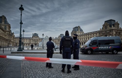 French police officers seal off the entrance to the Louvre Museum after a jewelry theft on Sunday. The interior ministry said the jewels had "inestimable heritage and historical value."