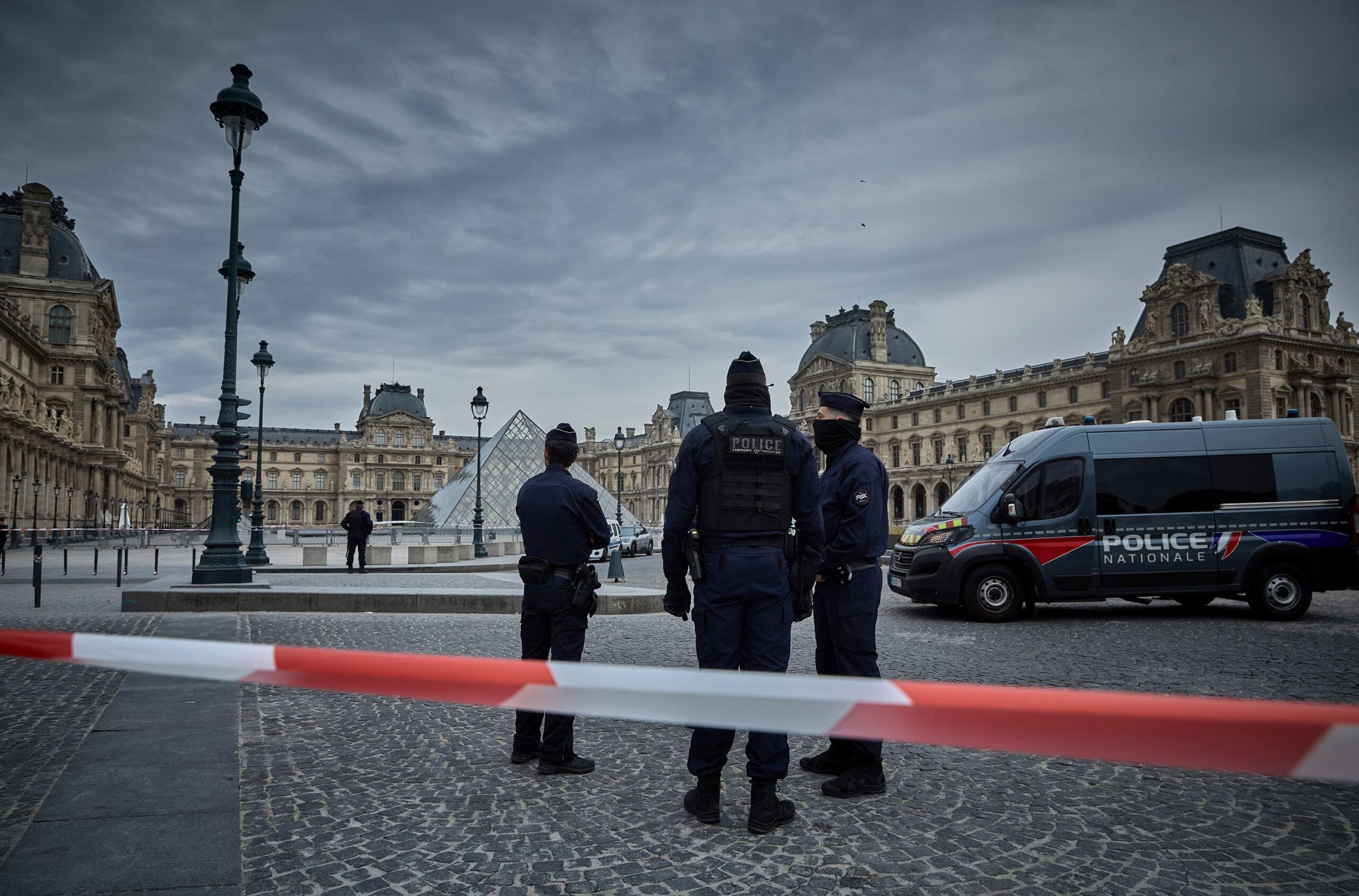 French police officers seal off the entrance to the Louvre Museum after a jewelry theft on Sunday. The interior ministry said the jewels had "inestimable heritage and historical value."