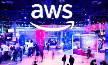 Amazon Web Services logo is displayed at a conference. The service went down for several hours Monday.