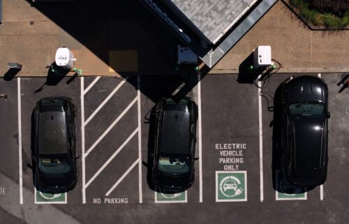 Electric cars sit parked at a charging station in California.