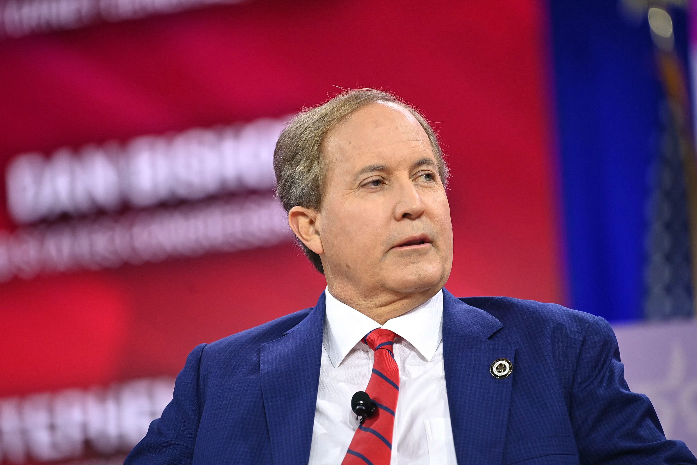 Texas Attorney General Ken Paxton speaks during a conference in February 2024 in National Harbor, Maryland. Paxton announced on October 8 that eight people have been charged in connection with clinics providing illegal abortions in Texas.