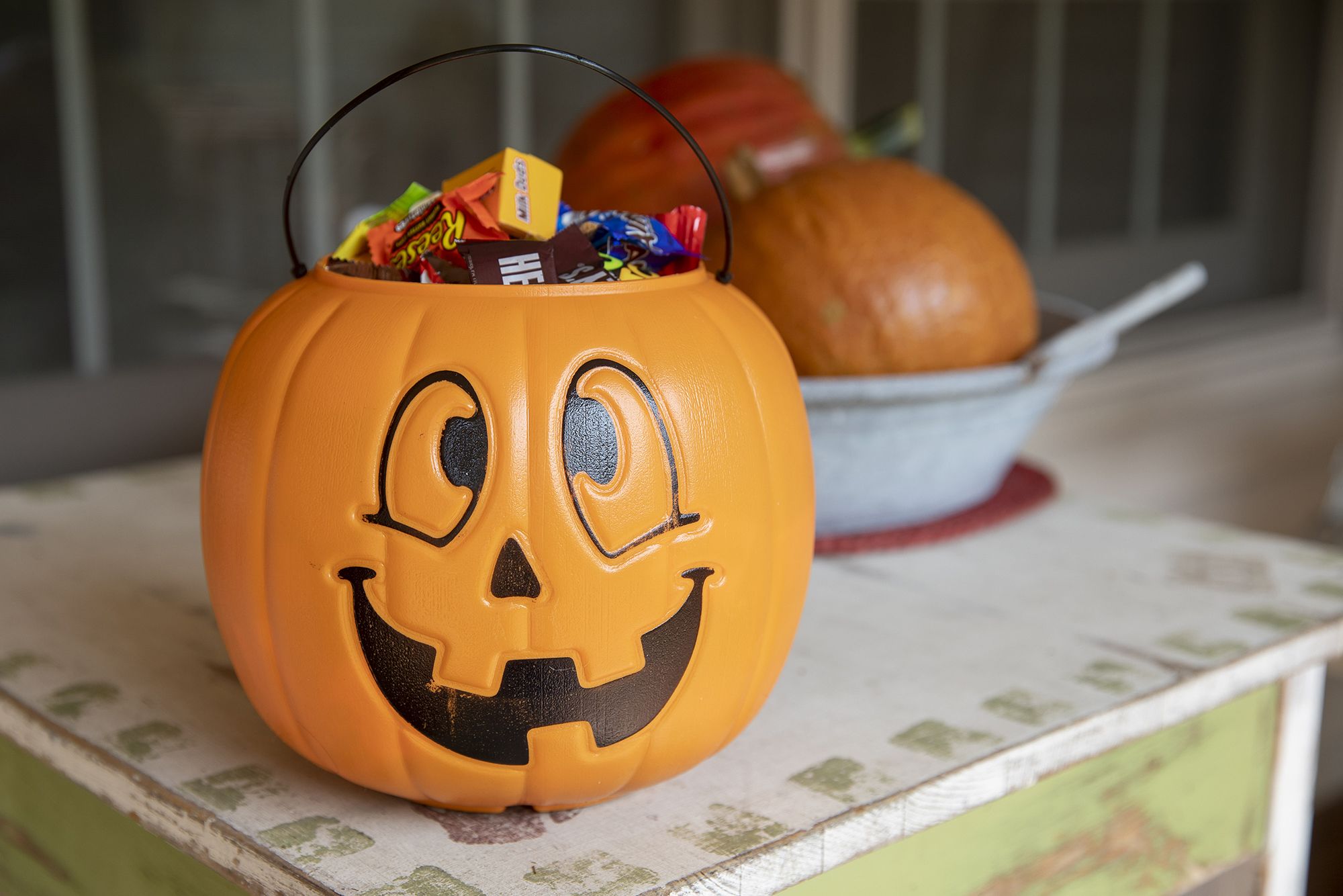 Halloween candy is displayed inside a pumpkin themed treat bucket in Tiskilwa