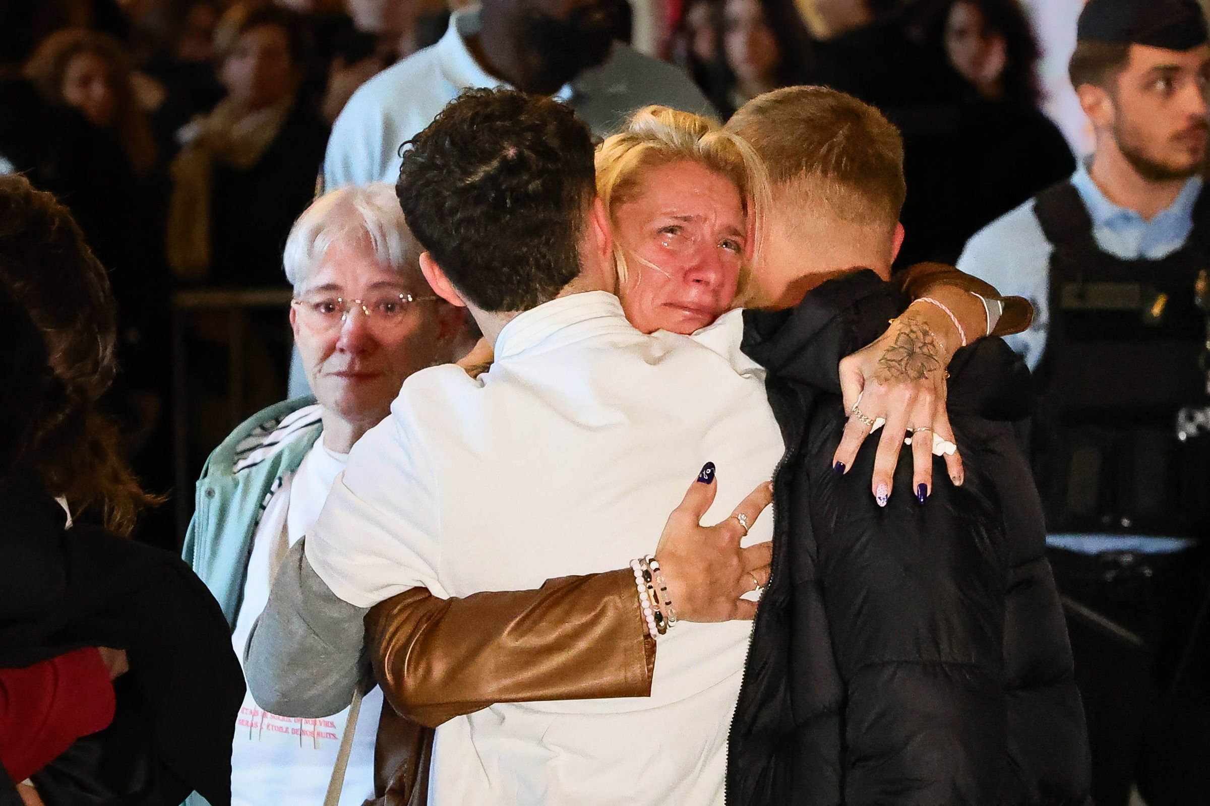 <i>Frederic Munsch/SIPA/AP via CNN Newsource</i><br/>Lola Daviet's family embrace after the Paris Assize Court sentenced Dahbia Benkired to life imprisonment without the possibility of parole.