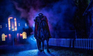 An attendee poses with an actor dressed as a gargoyle at Netherworld. Halloween revelers enjoy being scared because it offers a "catharsis" for our fears about death