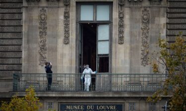 A French Forensics Officer examines the window and balcony of a gallery at Paris' Louvre Museum