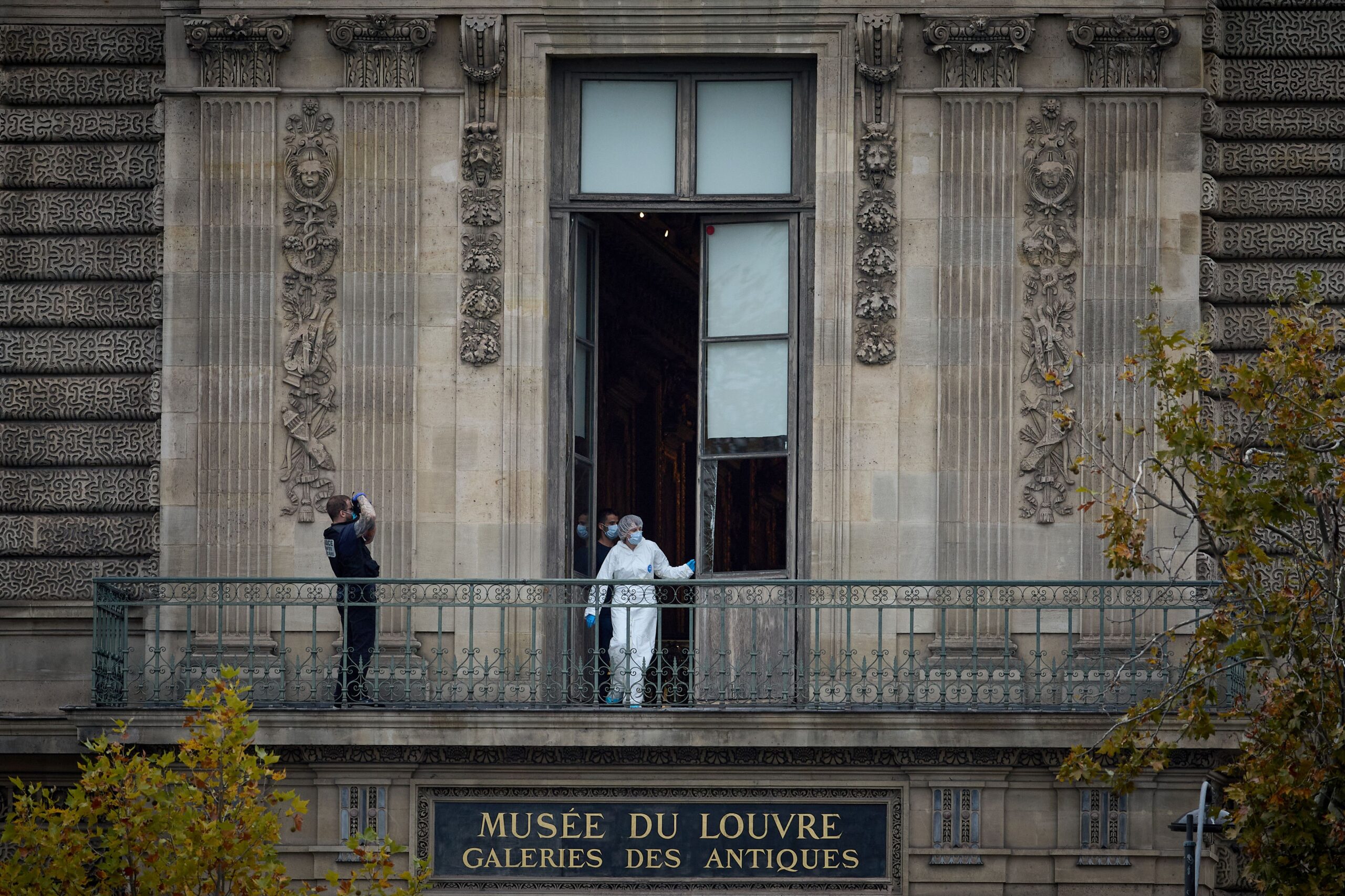 A French Forensics Officer examines the window and balcony of a gallery at Paris' Louvre Museum