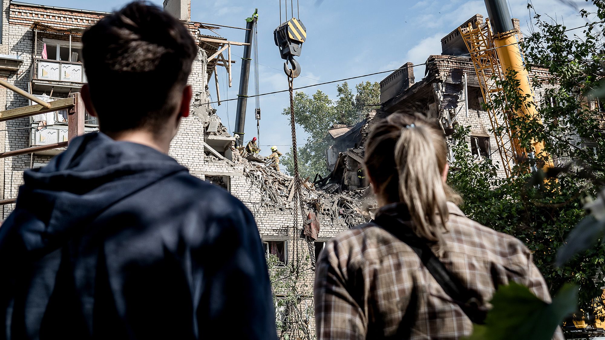 <i>Serhii Ovcharyshyn/Global Images Ukraine/Getty Images via CNN Newsource</i><br/>People look at a damaged residential apartment building after a Russian drone attack in Mykolaiv