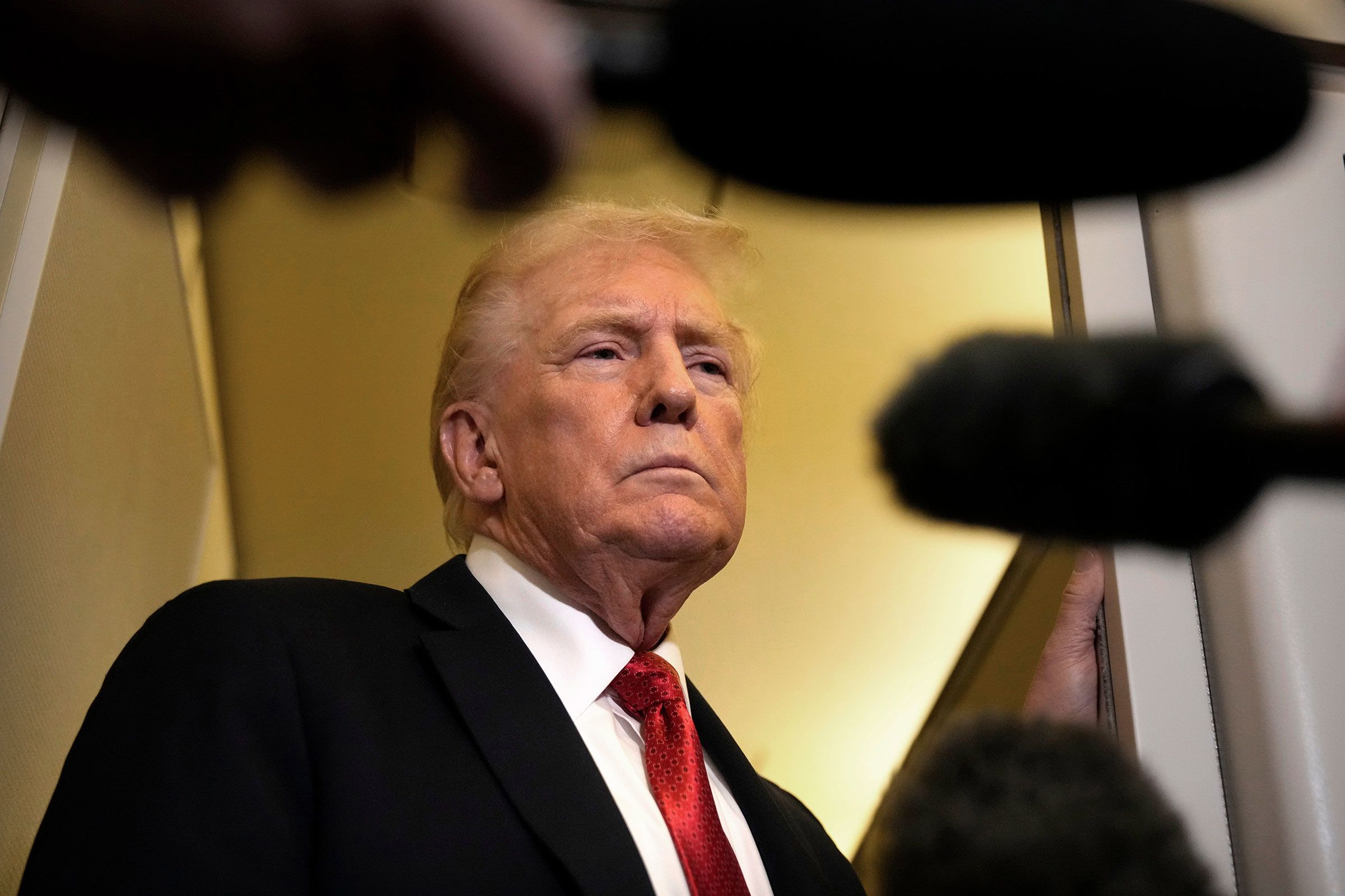 <i>Mark Schiefelbein/AP/File via CNN Newsource</i><br/>President Donald Trump speaks to reporters aboard Air Force One on Sunday