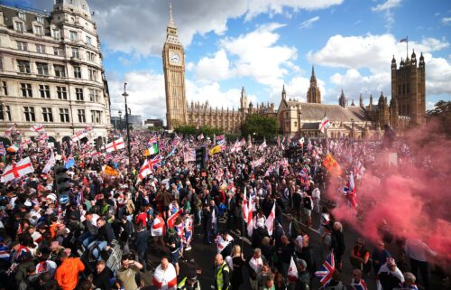 Anti-immigration protesters wave British and England flags during the "Unite The Kingdom" rally in London on September 13