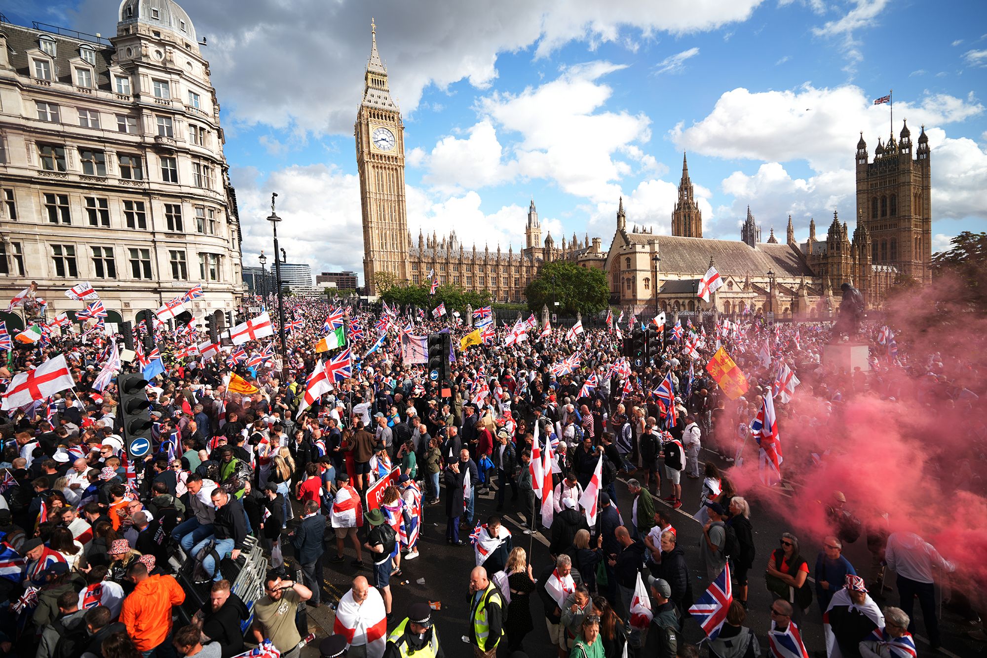 <i>Christopher Furlong/Getty Images via CNN Newsource</i><br/>Anti-immigration protesters wave British and England flags during the "Unite The Kingdom" rally in London on September 13