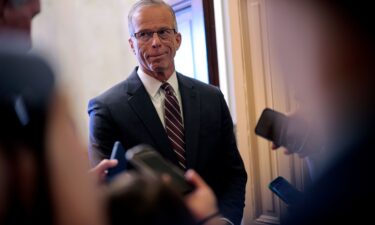 Senate Majority Leader John Thune talks to reporters while standing in the doorway of his office at the US Capitol on Wednesday