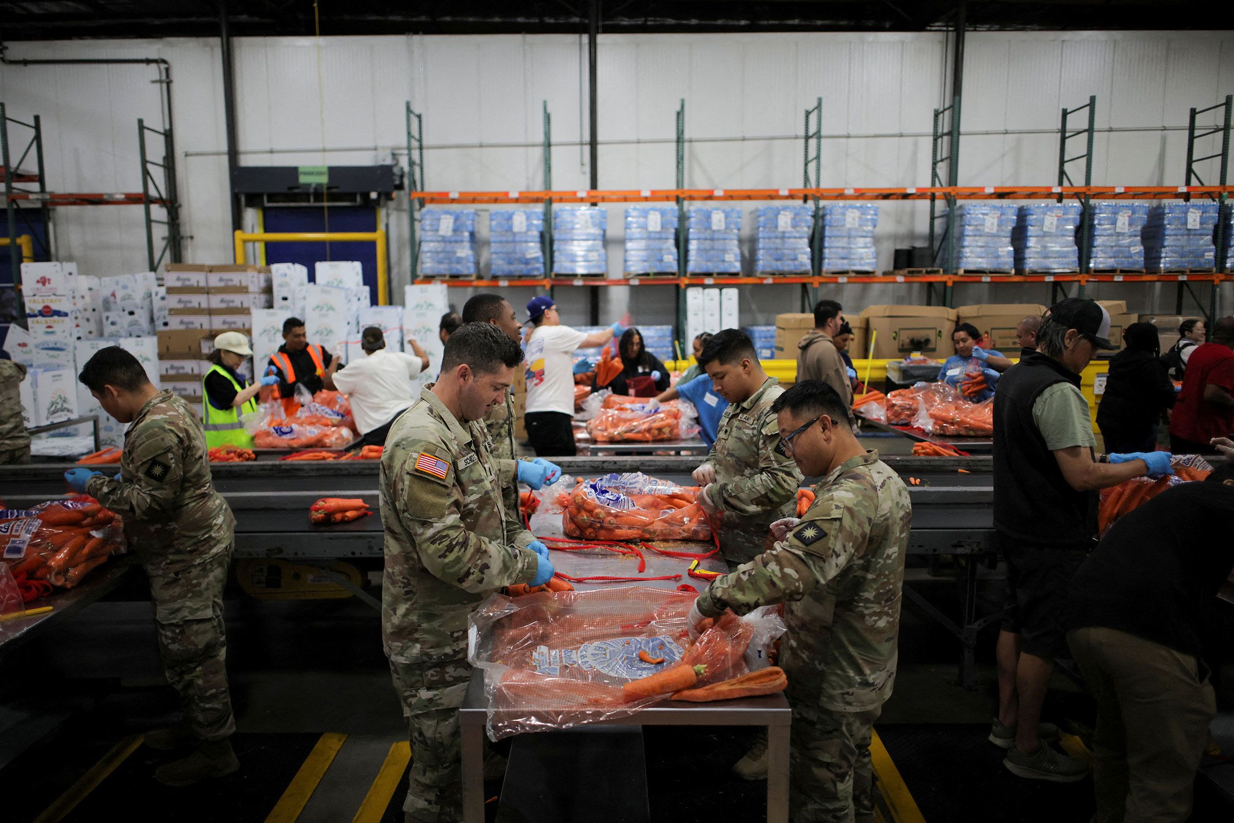Members of the National Guard pack food at a Los Angeles Regional Food Bank facility in Los Angeles