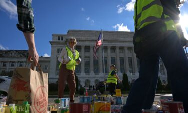 Furlogh federal workers and volunteers collect groceries during the People's Pantry Food drive to replenish food banks ahead of SNAP lapse at the USDA Headquarters