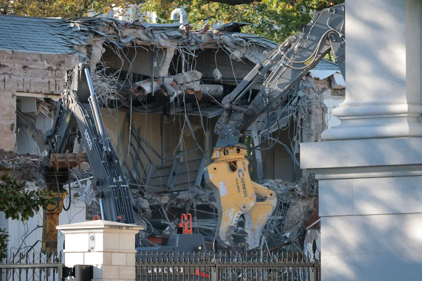 Workers demolish the facade of the East Wing of the White House on October 20, 2025.