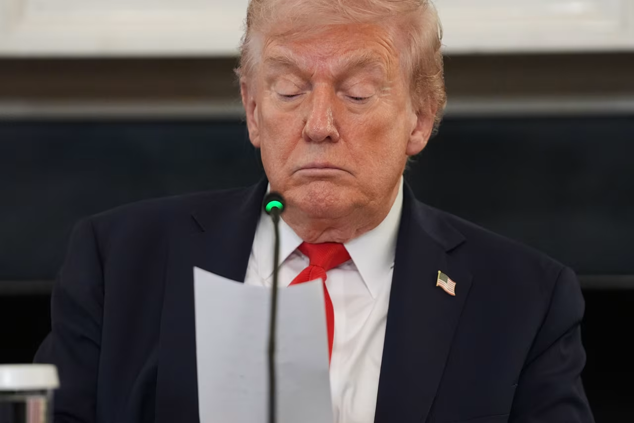 President Donald Trump reads a note handed to him by Secretary of State Marco Rubio at the White House on Wednesday.