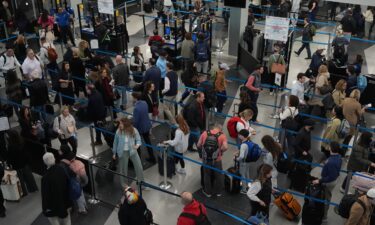 Travelers wait at a security checkpoint at O'Hare International Airport in Chicago