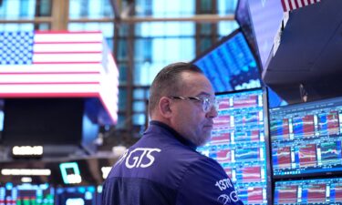 The Dow closed at a record high and had its best day in almost one month.