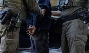 US federal agents detain a man during an immigration raid in the East Side neighborhood of Chicago on October 27.