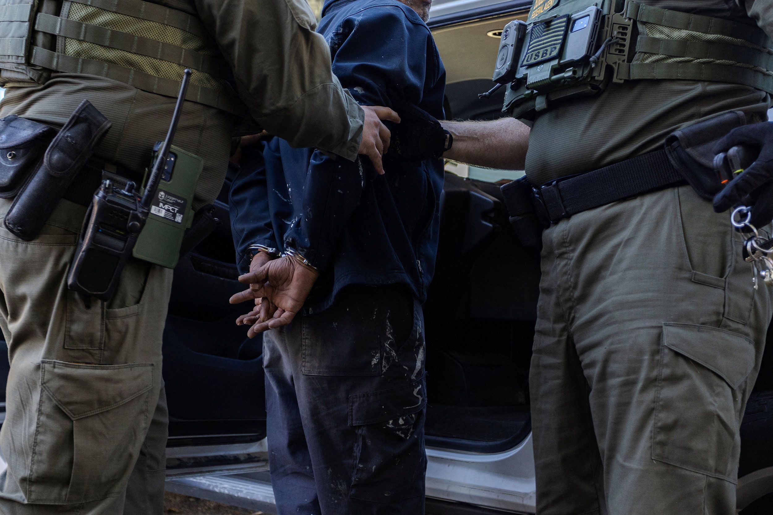 <i>Jim Vondruska/Reuters via CNN Newsource</i><br/>US federal agents detain a man during an immigration raid in the East Side neighborhood of Chicago on October 27.