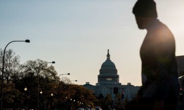 A vehicle passes trash seen strewn along the road at Joshua Tree National Park in California
