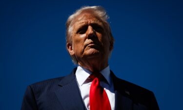 President Donald Trump speaks to reporters as he arrives at Palm Beach International Airport on October 31 in West Palm Beach