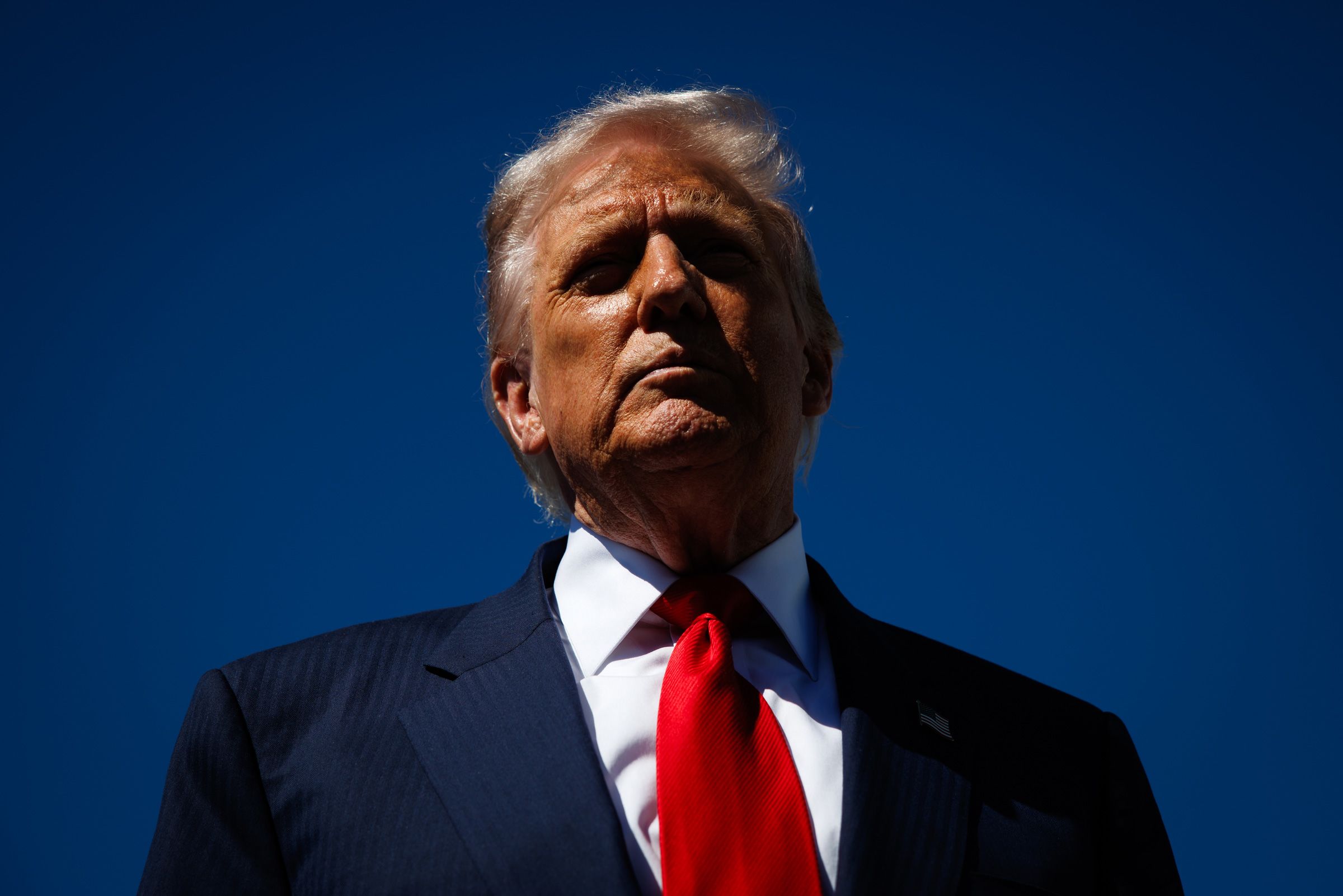 President Donald Trump speaks to reporters as he arrives at Palm Beach International Airport on October 31 in West Palm Beach