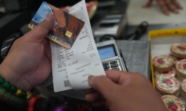 A man walks past an EBT payment sign posted on the front window of a grocery store in Philadelphia