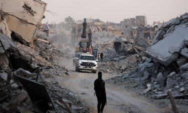 Red Cross vehicles drive through Gaza City before returning what was said to be the body of a deceased hostage held by Hamas to Israel on Tuesday.