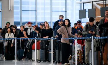 People wait in a security checkpoint line at George Bush Intercontinental Airport in Houston