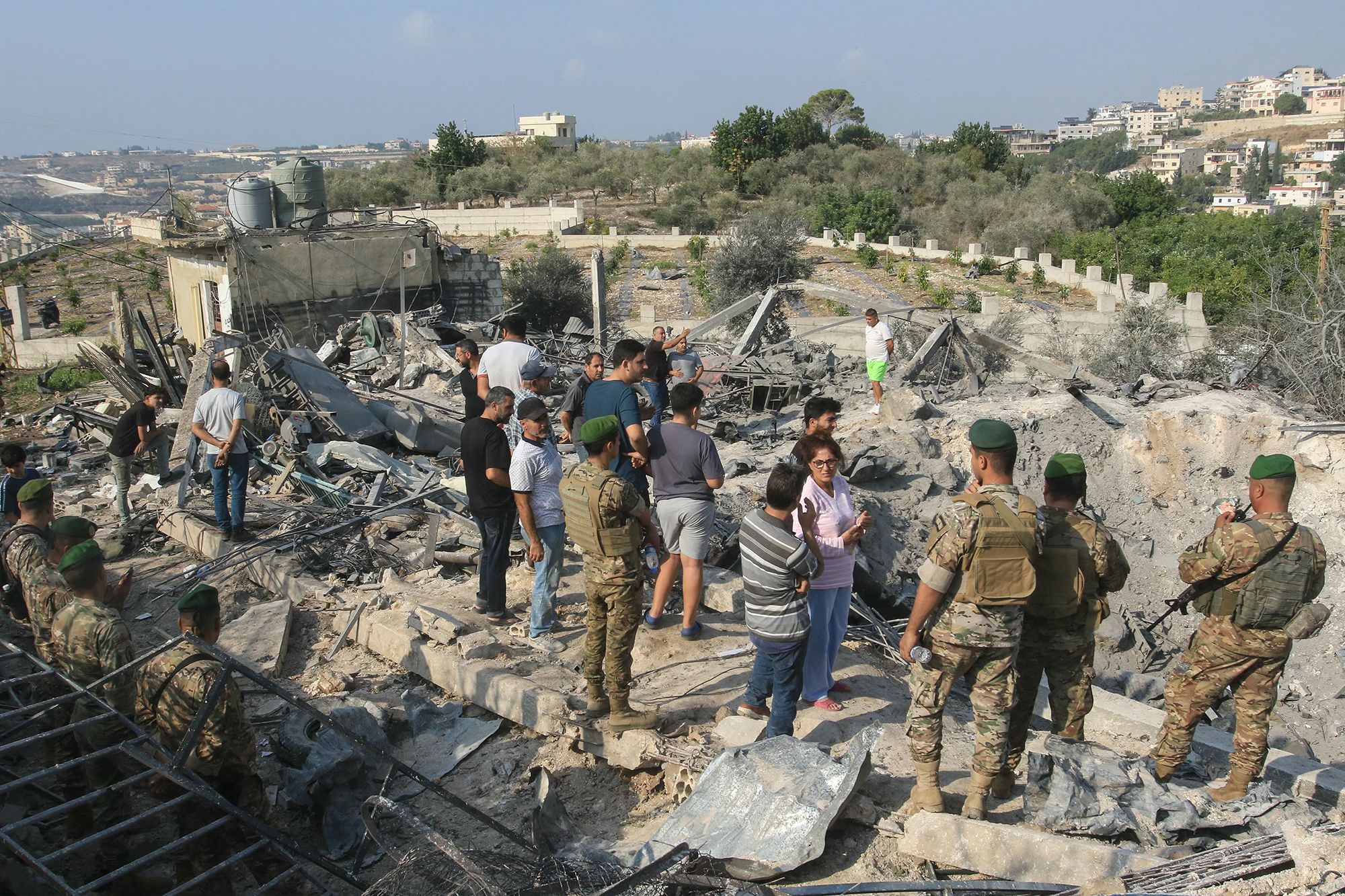 <i>Mahmoud Zayyat/AFP/Getty Images via CNN Newsource</i><br/>People assess the damage at the site of an Israeli airstrike in the southern Lebanese village of Toura on November 6.