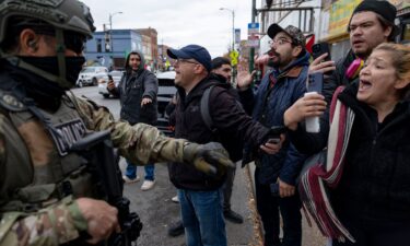 A person carries a whistle to alert community members of the presence of federal agents after an immigration raid in Chicago's Little Village neighborhood on November 8.