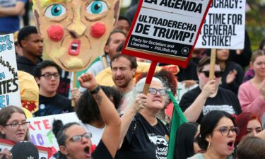 Protesters yell and hold signs Saturday