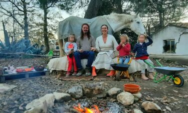 Nathan Trevallion and Catherine Birmingham pose for a picture with their children. A portion of this photo has been blurred by CNN to protect identities.