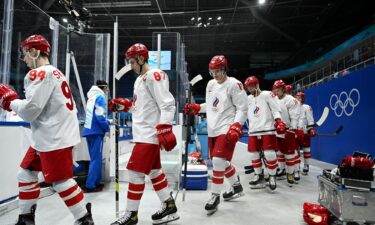 Satellite imagery of large craters and a damaged Olympic sports training center and stadium.