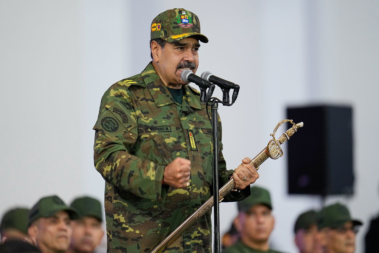 <i>Ariana Cubillos/AP via CNN Newsource</i><br/>Venezuelan President Nicolas Maduro grasps a sword during a government-organized civic-military rally in Caracas