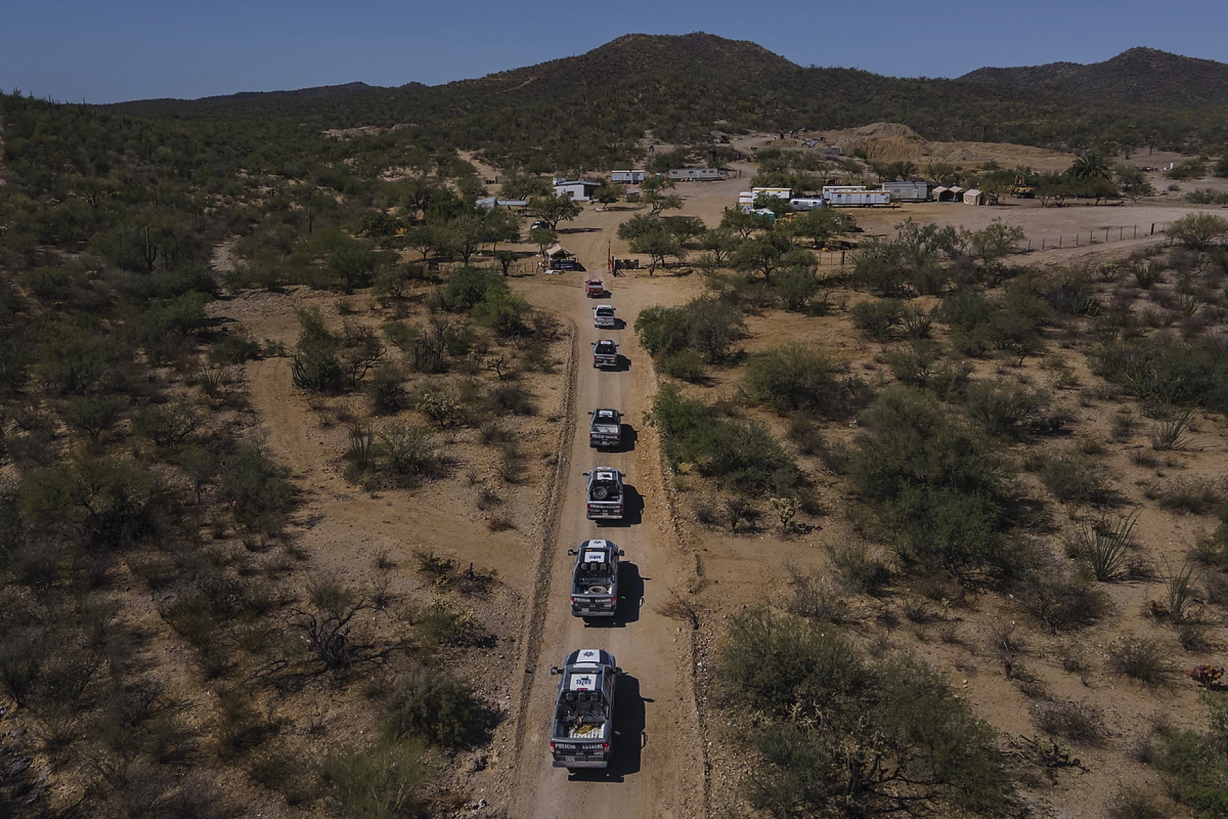 A convoy of state police vehicles arrives at the La Ciénega gold mine in the Mexican state of Sonora on June 23.