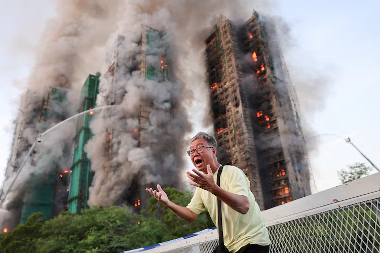 Wong 71, reacts after claiming his wife is trapped inside Wang Fuk Court during a major fire, in Tai Po, Hong Kong, China, Nov. 26, 2025.
