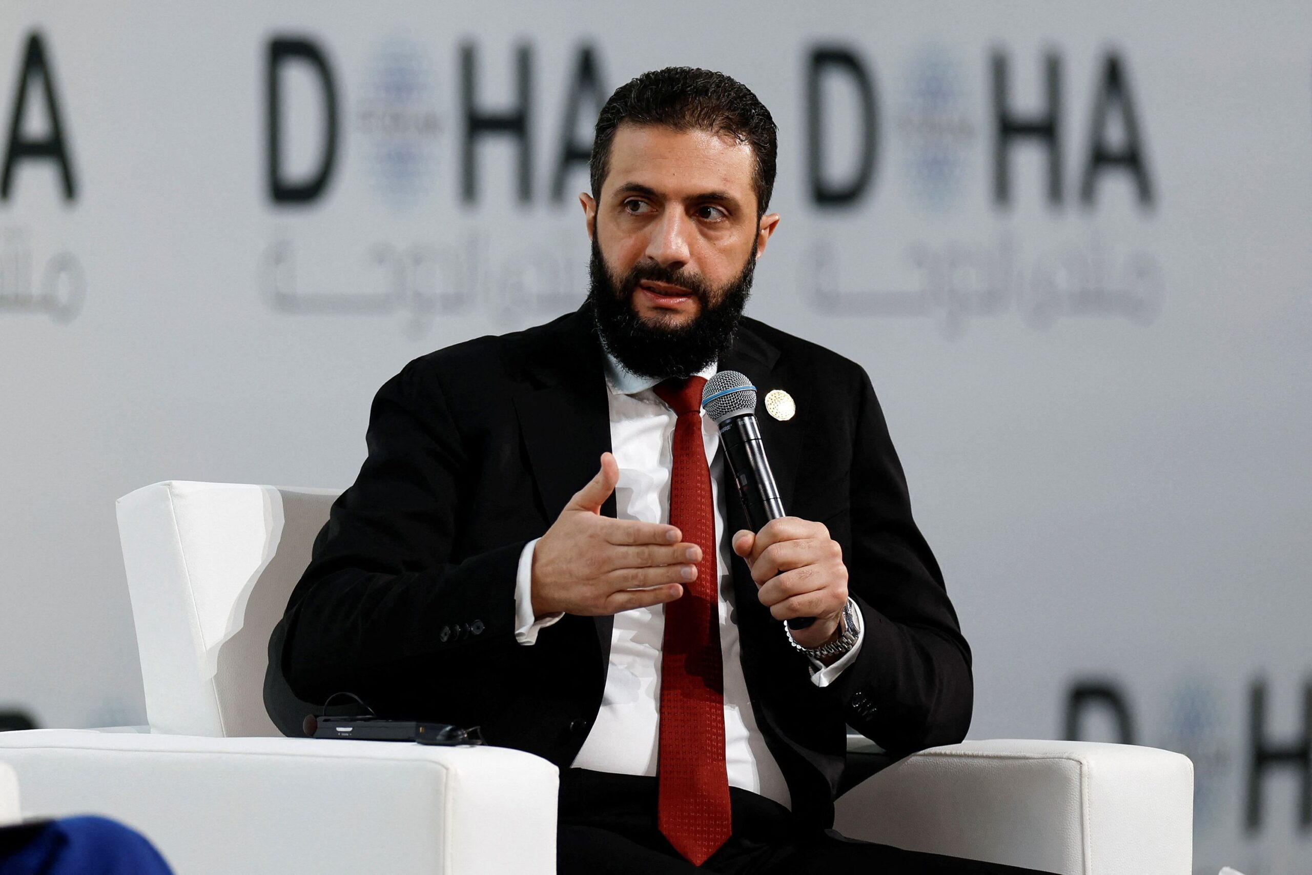 <i>Ibraheem Abu Mustafa/Reuters via CNN Newsource</i><br/>Syrian President Ahmed Al-Sharaa speaks as he attends the 23rd edition of the annual Doha Forum