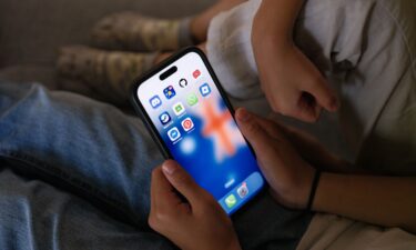 Australia's Prime Minister Anthony Albanese (C) as he speaks during an official function to mark the start of Australia's social media reform at Kirrilbilli House in Sydney on December 10