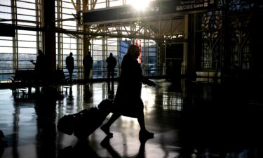 A traveler walks through Ronald Reagan Washington National Airport in Arlington